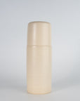 A beige ceramic carafe and tumbler set on a plain background.